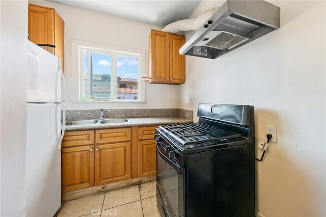 213 S Atlantic Blvd, Alhambra, CA 91801 - kitchen with freestanding refrigerator, black gas range, exhaust hood, brown cabinets, and light tile patterned floors