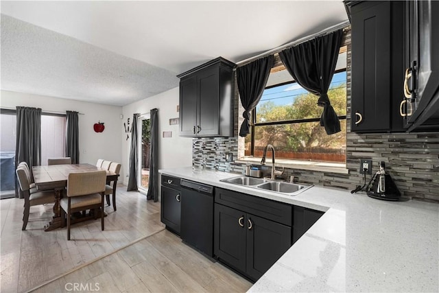 15060 Chatsworth St Unit E, San Fernando, CA 91345 - kitchen featuring dishwasher, dark cabinetry, backsplash, light stone counters, and a textured ceiling