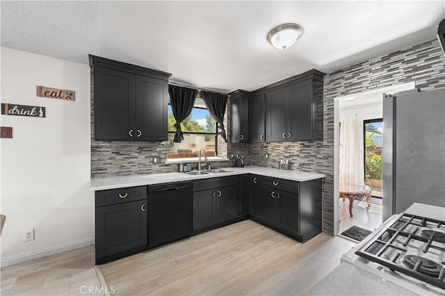 15060 Chatsworth St Unit E, San Fernando, CA 91345 - kitchen with dishwasher, freestanding refrigerator, light countertops, and decorative backsplash