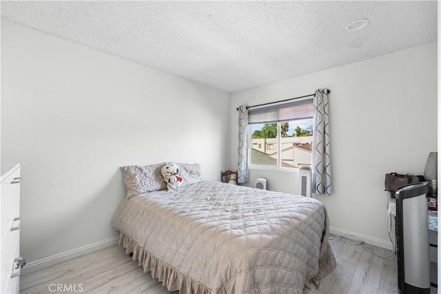 15060 Chatsworth St Unit E, San Fernando, CA 91345 - bedroom featuring wood finished floors and a textured ceiling