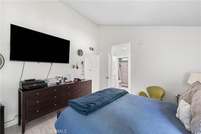 15060 Chatsworth St Unit E, San Fernando, CA 91345 - bedroom featuring vaulted ceiling, light wood-style floors, and connected bathroom