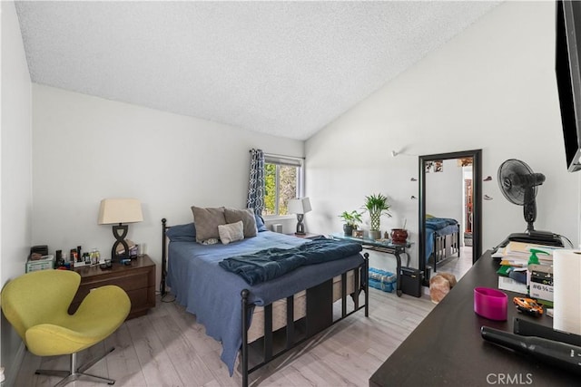 15060 Chatsworth St Unit E, San Fernando, CA 91345 - bedroom featuring light wood-type flooring, vaulted ceiling, and a textured ceiling