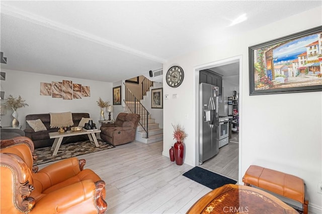 15060 Chatsworth St Unit E, San Fernando, CA 91345 - living area featuring light wood-style floors and stairs