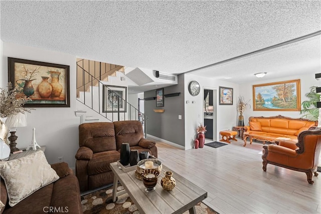 15060 Chatsworth St Unit E, San Fernando, CA 91345 - living room with a textured ceiling, stairway, and wood finished floors