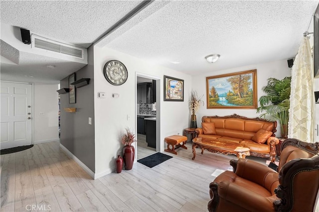 15060 Chatsworth St Unit E, San Fernando, CA 91345 - living room with a textured ceiling and light wood finished floors