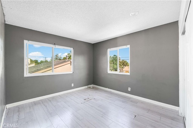 15060 Chatsworth St Unit E, San Fernando, CA 91345 - spare room with a textured ceiling and wood finished floors