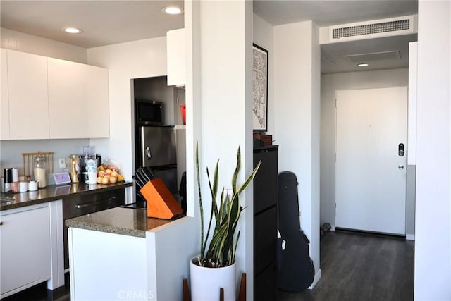 100 Atlantic Ave Unit 906, Long Beach, CA 90802 - kitchen with freestanding refrigerator, white cabinets, dark wood finished floors, black microwave, and recessed lighting