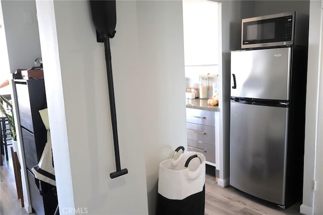 100 Atlantic Ave Unit 906, Long Beach, CA 90802 - kitchen with appliances with stainless steel finishes, light wood-type flooring, and white cabinetry