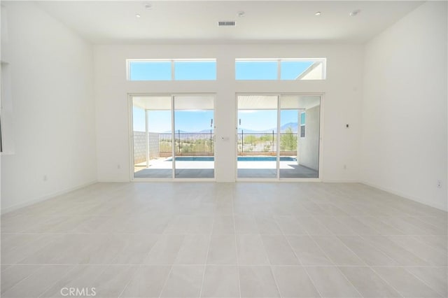 193 Mustang Ln, Palm Springs, CA 92262 - spare room featuring light tile patterned flooring and a high ceiling