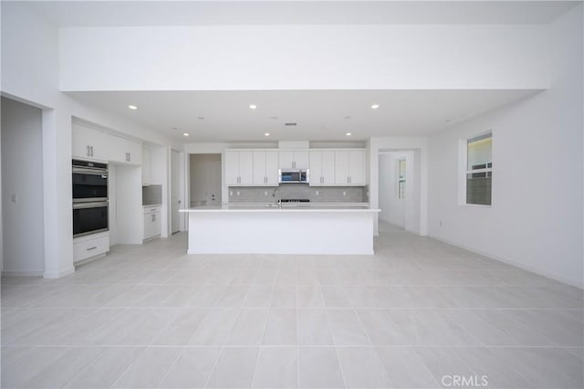 193 Mustang Ln, Palm Springs, CA 92262 - kitchen featuring stainless steel appliances, recessed lighting, white cabinets, light countertops, and backsplash