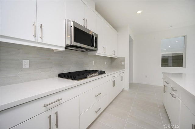 193 Mustang Ln, Palm Springs, CA 92262 - kitchen with appliances with stainless steel finishes, decorative backsplash, light countertops, white cabinetry, and recessed lighting