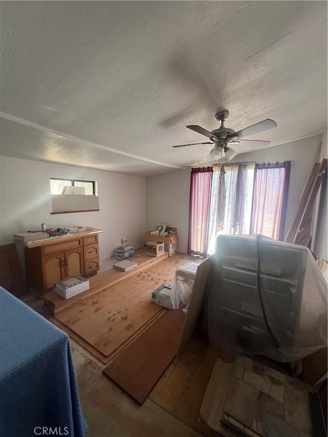 56554 Rd 200, North Fork, CA 93643 - bedroom with wood finished floors, a textured ceiling, and a ceiling fan