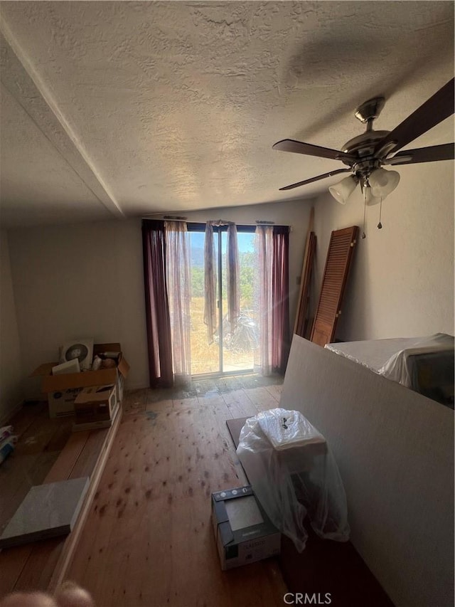 56554 Rd 200, North Fork, CA 93643 - living room with wood-type flooring, a textured ceiling, and ceiling fan
