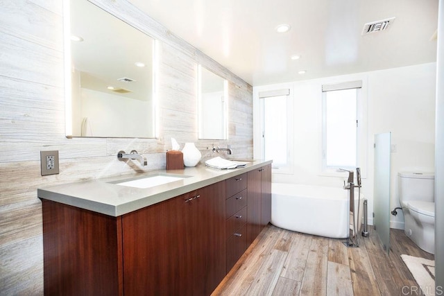 12794 Via Felino, Del Mar, CA 92014 - bathroom with a freestanding tub, double vanity, wood finished floors, and decorative backsplash