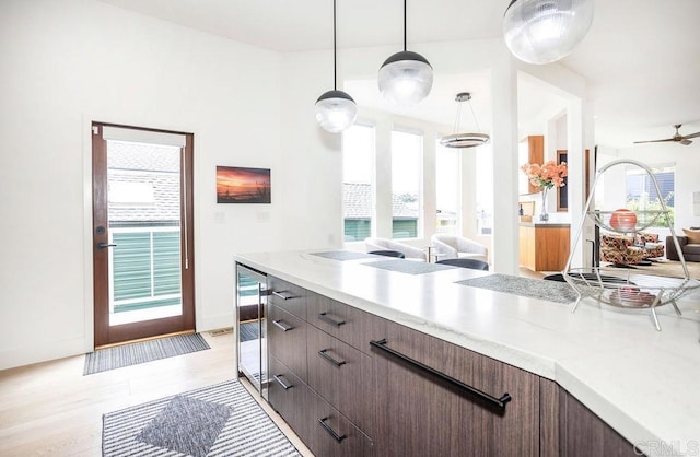12794 Via Felino, Del Mar, CA 92014 - kitchen featuring open floor plan, wine cooler, healthy amount of natural light, and light wood finished floors