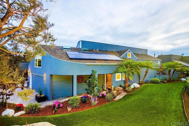12794 Via Felino, Del Mar, CA 92014 - view of front of home with a front lawn, roof mounted solar panels, an attached garage, and stucco siding