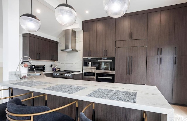12794 Via Felino, Del Mar, CA 92014 - kitchen with wall chimney exhaust hood, appliances with stainless steel finishes, light stone counters, dark brown cabinets, and backsplash