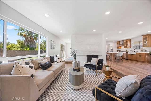 1809 Celeste Ln, Fullerton, CA 92833 - living room featuring recessed lighting, light wood finished floors, and a brick fireplace