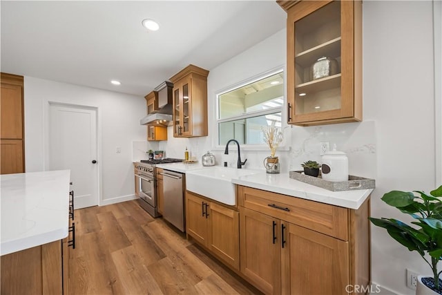 1809 Celeste Ln, Fullerton, CA 92833 - kitchen featuring wall chimney exhaust hood, stainless steel appliances, brown cabinets, wood finished floors, and recessed lighting