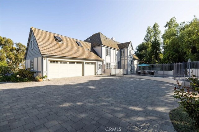 31681 Peppertree, San Juan Capistrano, CA 92675 - view of side of property with decorative driveway and a garage
