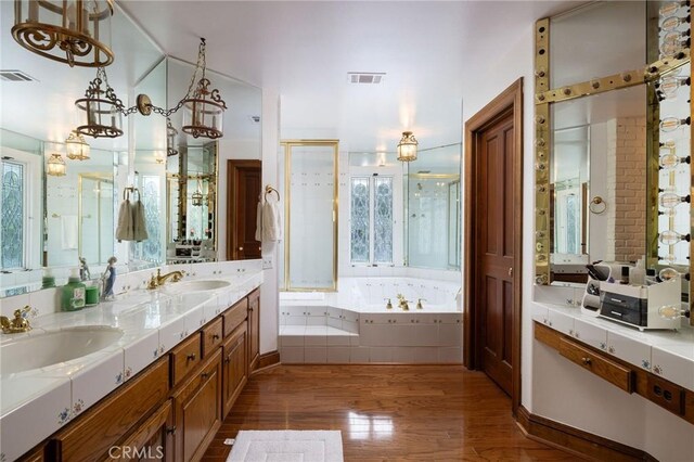 31681 Peppertree, San Juan Capistrano, CA 92675 - bathroom with a bath, wood finished floors, double vanity, and a stall shower