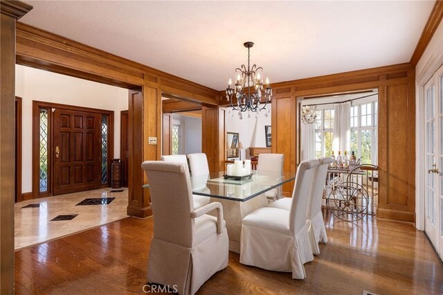 31681 Peppertree, San Juan Capistrano, CA 92675 - dining area featuring a chandelier, wood finished floors, and wood walls