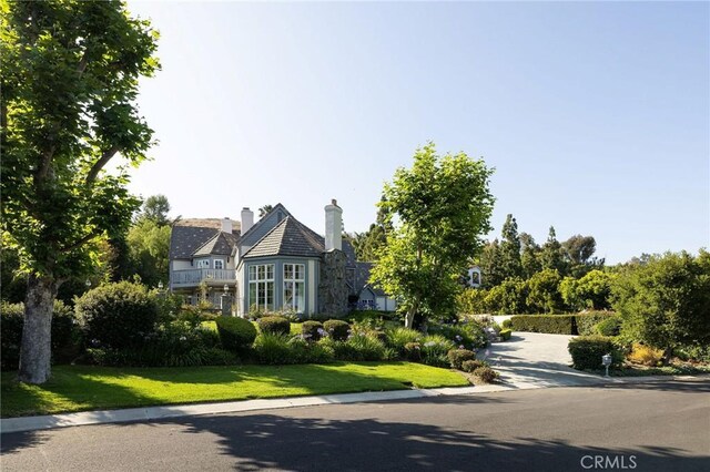 31681 Peppertree, San Juan Capistrano, CA 92675 - tudor house with a front yard and a chimney