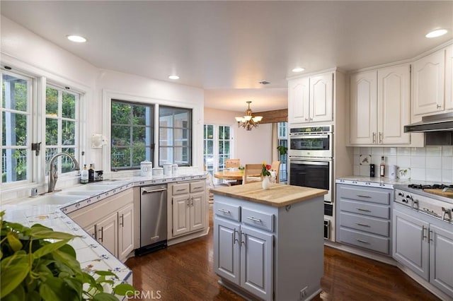 31681 Peppertree, San Juan Capistrano, CA 92675 - kitchen with gray cabinetry, appliances with stainless steel finishes, a chandelier, healthy amount of natural light, and recessed lighting