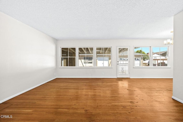 2056 Fulton Ave, Monterey Park, CA 91755 - unfurnished living room with a chandelier, wood finished floors, and a textured ceiling