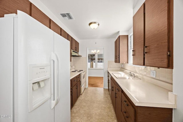 2056 Fulton Ave, Monterey Park, CA 91755 - kitchen featuring white appliances, under cabinet range hood, tasteful backsplash, and light countertops