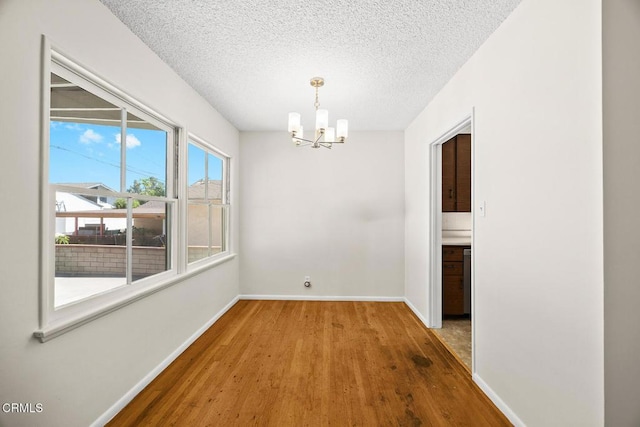2056 Fulton Ave, Monterey Park, CA 91755 - unfurnished dining area with wood finished floors, a chandelier, and a textured ceiling