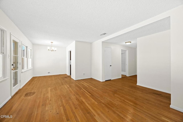 2056 Fulton Ave, Monterey Park, CA 91755 - unfurnished room with a chandelier, light wood-style flooring, and a textured ceiling