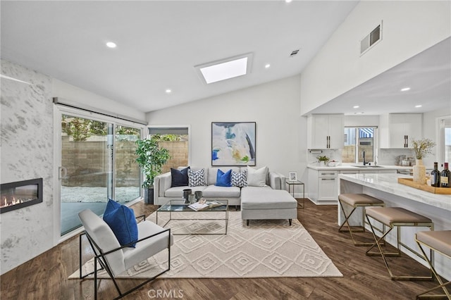 6 Crockett, Irvine, CA 92620 - living area with lofted ceiling, dark wood-style floors, a skylight, healthy amount of natural light, and recessed lighting