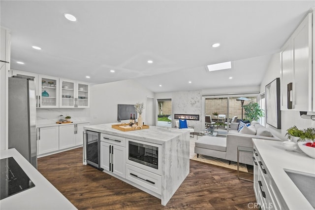 6 Crockett, Irvine, CA 92620 - kitchen with beverage cooler, appliances with stainless steel finishes, open floor plan, dark wood-type flooring, and white cabinetry