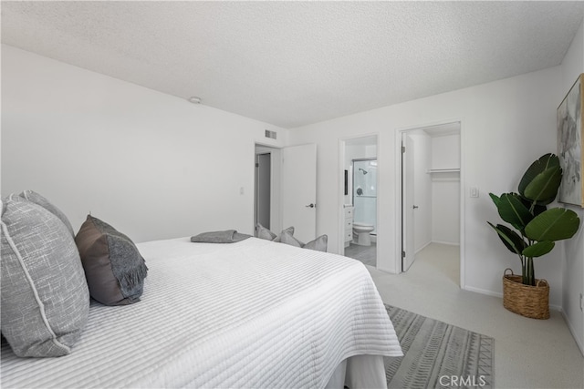 19721 Dunsmuir Plz, Yorba Linda, CA 92886 - carpeted bedroom featuring a textured ceiling, a spacious closet, and ensuite bath