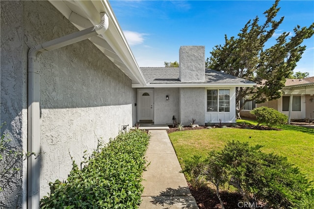 19721 Dunsmuir Plz, Yorba Linda, CA 92886 - property entrance with stucco siding, a lawn, and a chimney
