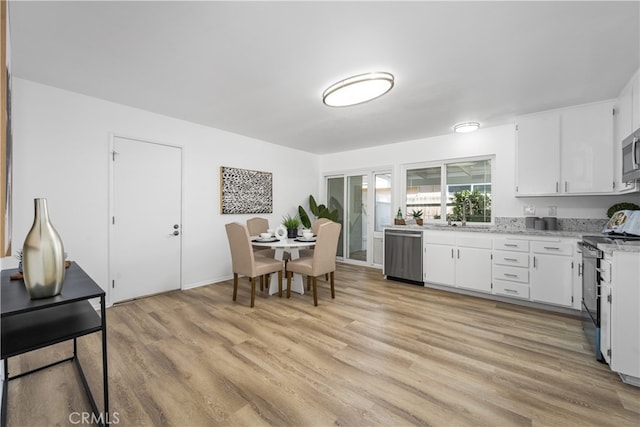 19721 Dunsmuir Plz, Yorba Linda, CA 92886 - kitchen with appliances with stainless steel finishes, light wood-type flooring, white cabinets, and light stone countertops
