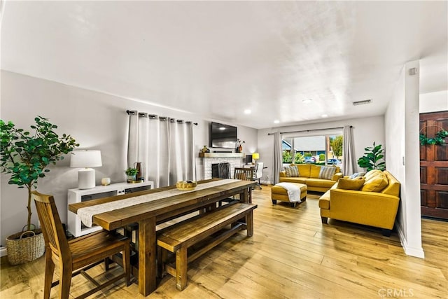 8110 True Ave, Pico Rivera, CA 90660 - dining area featuring a brick fireplace, light wood-type flooring, and recessed lighting