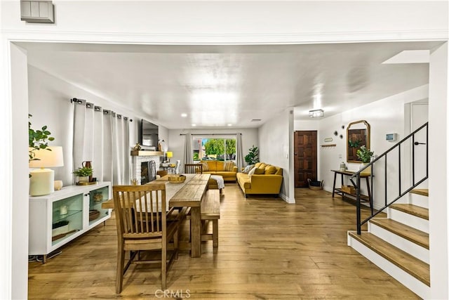 8110 True Ave, Pico Rivera, CA 90660 - dining room with wood finished floors, a fireplace, and stairway