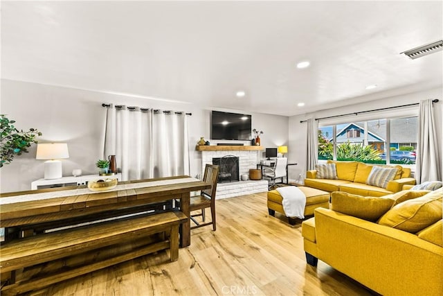 8110 True Ave, Pico Rivera, CA 90660 - living area featuring a fireplace, light wood finished floors, and recessed lighting