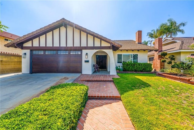 8110 True Ave, Pico Rivera, CA 90660 - view of front facade featuring a chimney, a tile roof, stucco siding, an attached garage, and a front yard