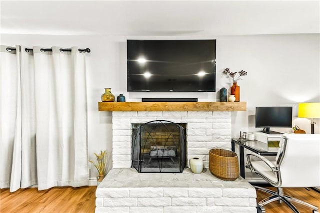 8110 True Ave, Pico Rivera, CA 90660 - living area featuring wood finished floors and a brick fireplace