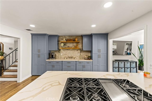 8110 True Ave, Pico Rivera, CA 90660 - kitchen with wood finished floors, recessed lighting, gas stovetop, backsplash, and open shelves