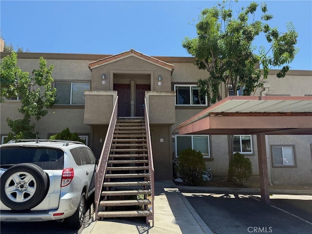 800 Grand Ave Unit A12, Diamond Bar, CA 91765 - view of property featuring covered and uncovered parking and stairs