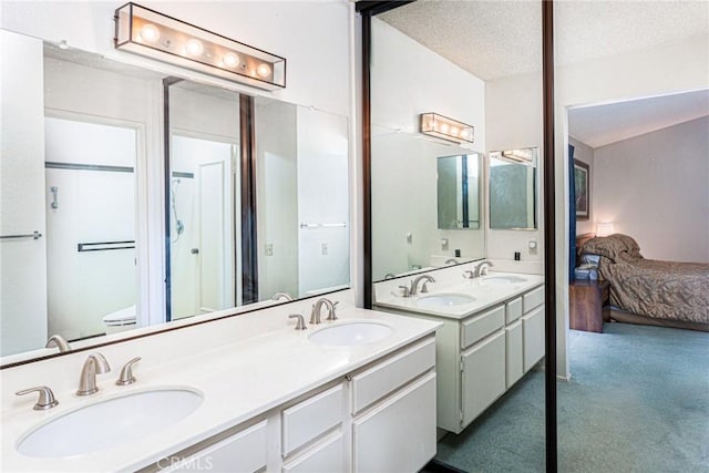 5870 Winncliff Dr, Jurupa Valley, CA 92509 - ensuite bathroom featuring double vanity and a textured ceiling