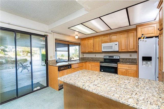 5870 Winncliff Dr, Jurupa Valley, CA 92509 - kitchen featuring white appliances, light stone countertops, light colored carpet, and a peninsula