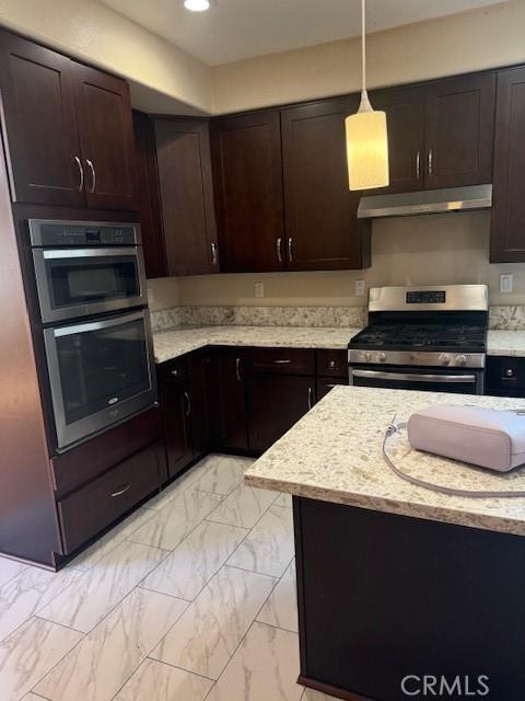 330 E Concord Way, Placentia, CA 92870 - kitchen featuring appliances with stainless steel finishes, under cabinet range hood, light marble finish flooring, dark brown cabinets, and recessed lighting