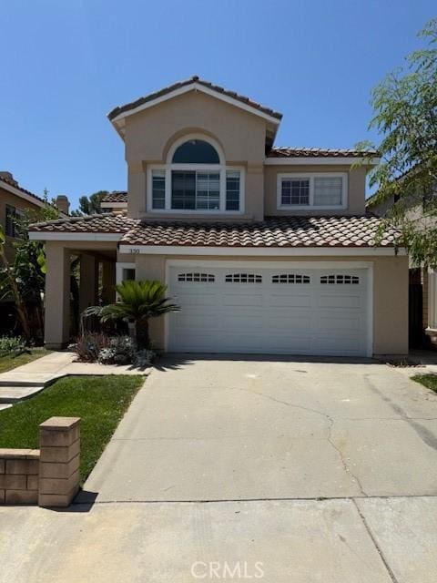 330 E Concord Way, Placentia, CA 92870 - mediterranean / spanish house with a tile roof, driveway, a garage, and stucco siding