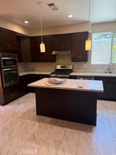 330 E Concord Way, Placentia, CA 92870 - kitchen featuring stainless steel appliances, under cabinet range hood, a center island, light marble finish flooring, and dark brown cabinets