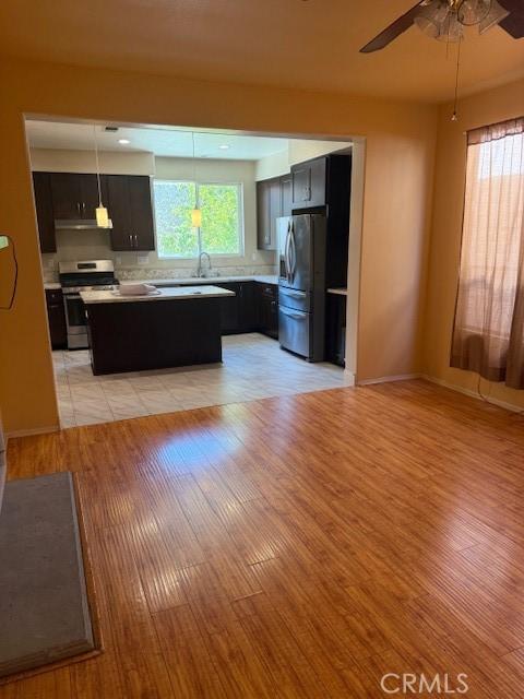 330 E Concord Way, Placentia, CA 92870 - kitchen featuring stainless steel appliances, light wood finished floors, light countertops, a center island, and ceiling fan
